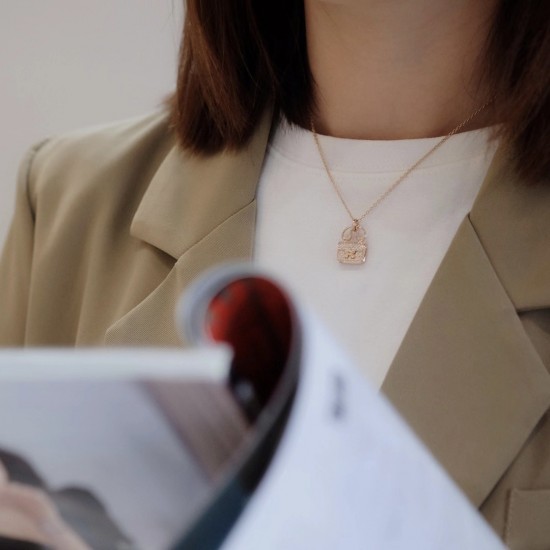 Hermes Pendant in rose gold set with diamonds and Kelly snap closure