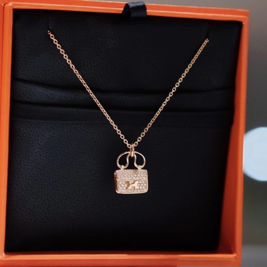 Hermes Pendant in rose gold set with diamonds and Kelly snap closure