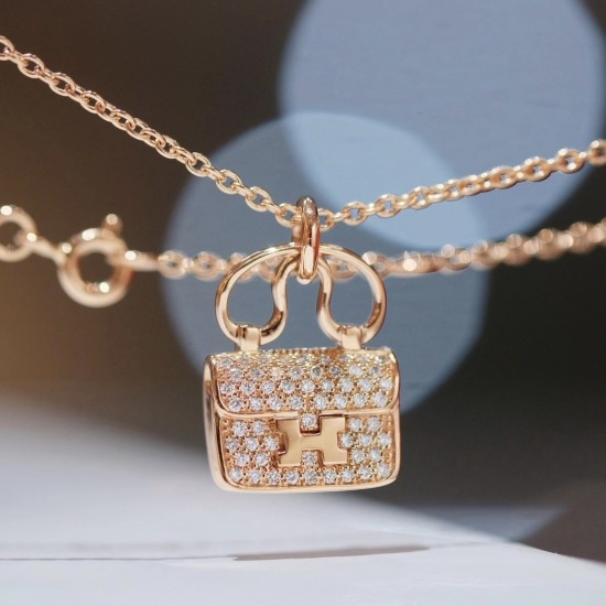 Hermes Pendant in rose gold set with diamonds and Kelly snap closure