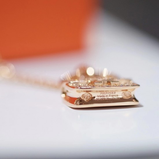 Hermes Pendant in rose gold set with diamonds and Kelly snap closure